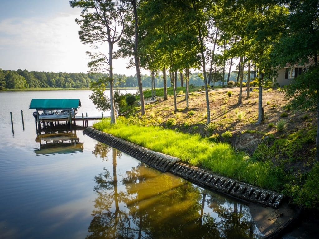 Completed living shoreline restoration with marsh grass planted along the waterfront, by Native Shorelines