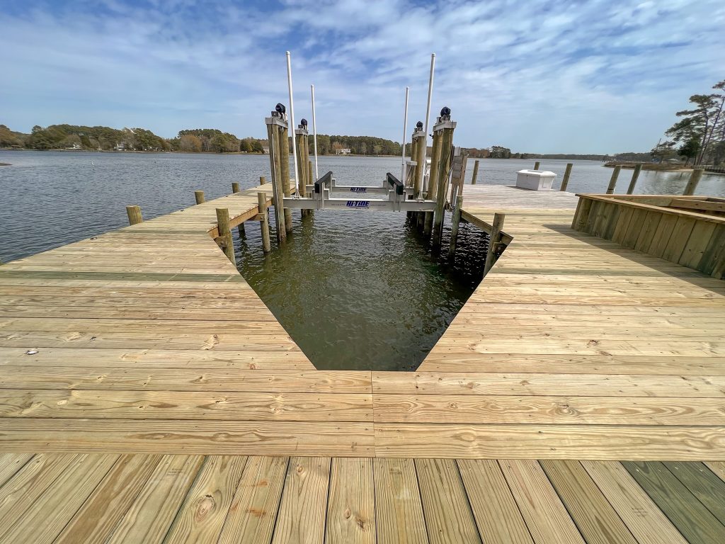 Wide new pier with a boat slip and boat lift, built by Early Marine Construction