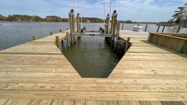 Wide new pier with a boat slip and boat lift, built by Early Marine Construction