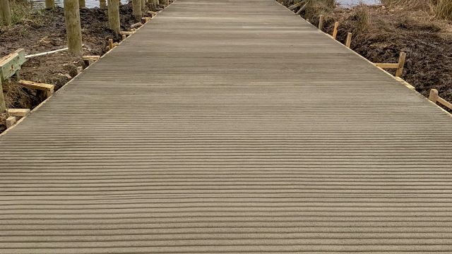 Newly poured concrete boat ramp leading to the water, built by Early Marine Construction
